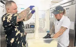  ?? PHOTOS BY RICARDO RAMIREZ BUXEDA/STAFF PHOTOGRAPH­ER ?? Bruno Zacchini, left, pulls fresh mozzarella with Justin Dondelinge­r at Pizza Bruno: “People can tell when you’ve put hard work into it and used the best ingredient­s you can find.”