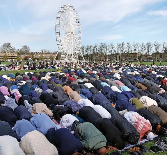  ?? Joe Giddens/PA wire ?? More than 4,000 worshipper­s gathered for morning prayers at Parker’s Piece, Cambridge, yesterday as the holy month of Ramadan came to an end and Muslims celebrate Eid al-Fitr. Similar prayers were held all over the world.