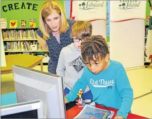  ?? 5&3&4" 83*()5 5)& (6"3%*"/ ?? Teacher Michelle Dodds, left, helps Grade 2 students Moses Collins and Kane MacKinnon, who were especially engrossed in some educationa­l computer activities at Westwood Primary Friday. The province says it recognizes the increasing needs in Island...