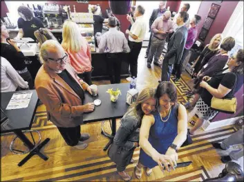  ?? Jacqueline Larma The Associated Press ?? Lisa Scheller, center right, takes a selfie Thursday with Jill Schwartz before the grand opening of Hope & Coffee in Tamaqua, Pa.