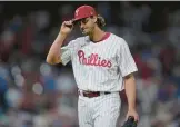  ?? MATT ROURKE/AP ?? Phillies pitcher Aaron Nola tips his cap to fans after being relieved during the eighth inning Monday against the Rockies in Philadelph­ia.