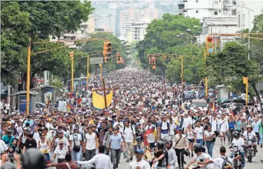  ?? ASSOCIATED PRESS ?? Thousands of people turn out for a march Saturday in Caracas, Venezuela, to honor at least 20 people killed in anti-government protests. Venezuelan­s are dealing with triple-digit inflation and widespread shortages of food and medical supplies.