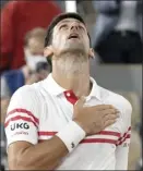  ?? AP photo ?? Novak Djokovic puts his hand on his heart after defeating Rafael Nadal in the French Open semifinals Friday.