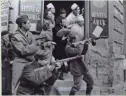  ?? AP ?? Hungarian freedom fighters battle secret police in the streets of Budapest during the 1956 revolt.