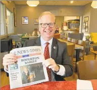  ?? Jacqueline Smith / Hearst Connecticu­t Media ?? Mayor Mark Boughton shows the local newspaper the day after winning an unpreceden­ted 10th term.