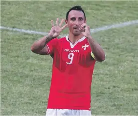  ??  ?? Mifsud signals his 40th goal for his country after scoring against Azerbaijan in September of 2015.