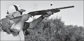  ?? Arkansas Democrat-Gazette/BRYAN HENDRICKS ?? Skip Henry fires at a pheasant Sept. 20 in South Dakota.