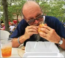  ?? EVAN BRANDT — DIGITAL FIRST MEDIA ?? Richard Ellis, a resident of Maple Street in Pottstown, tucks into an Italian hoagie from Bucktown’s Monsanto Bros. at Sunday’s 13th Annual Carousel of Flavor.