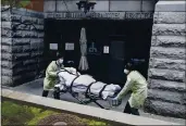  ?? JOHN MINCHILLO — THE ASSOCIATED PRESS FILE ?? A patient is wheeled out of the Cobble Hill Health Center nursing home by emergency medical workers in the Brooklyn borough of New York.