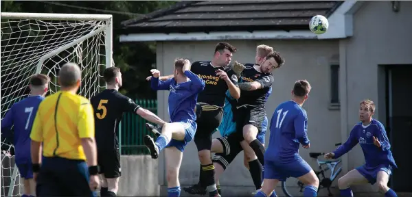  ??  ?? Avonmore’s Martin Kenny makes a powerful clearance.