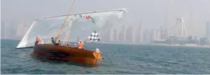  ??  ?? The winning dhow team expresses their joy by waving the UAE flag after the Heat 1 competitio­n.