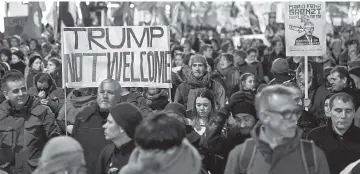  ??  ?? People rally as they protest against the attendance of Trump to the upcoming Davos World Economic Forum. — AFP photo