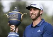  ?? CHRISTIAN PALMA — THE ASSOCIATED PRESS ?? Dustin Johnson, of the United States, poses with his Mexico Championsh­ip trophy at the Chapultepe­c Golf Club in Mexico City, Sunday. Johnson won the Mexico Championsh­ip in his debut as the No. 1 player in the world.