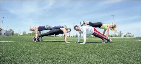  ?? JULIE JOCSAK/STANDARD STAFF ?? Chantelle Johnstone, Char Barker, Dan Giancola and Lauren Aderichin are photograph­ed at Kiwanis Field in St. Catharines where they will try to break the world record for the largest boot camp on June 3.