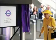  ?? (AP/Andrew Matthews) ?? Queen Elizabeth II unveils a plaque to mark the Elizabeth line’s official opening at Paddington station Tuesday in London, to mark the completion of London’s Crossrail project.