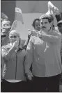  ?? AP/BORIS VERGARA ?? (left) hangs on to a truck carrying humanitari­an aid Saturday in Cucuta, Colombia. Guaido plans to meet Monday with Vice President Mike Pence in Bogota. At right, Venezuelan President Nicolas Maduro and his wife, Cilia Flores, greet supporters at a rally Saturday in Caracas.