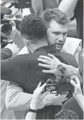  ?? MICHAEL CHOW/ARIZONA REPUBLIC ?? The Suns’ Devin Booker congratula­tes Dallas’ Luka Doncic after Game 7 of the Western Conference semifinals.