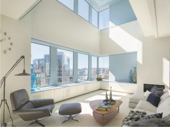  ?? Jacob Elliott ?? A double-height ceiling shelters the living area at 690 Market St., Unit 2402, a two-story penthouse at the Ritz-Carlton.