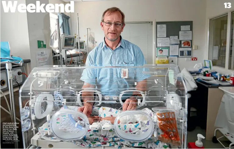  ?? PHOTO: MARION VAN DIJK/FAIRFAX NZ ?? Chief medical officer and paediatric­ian Dr Nick Baker in the Special Care Baby Unit at Nelson Hospital, with Lennox Robertson, foreground, and his twin brother Jarvis.