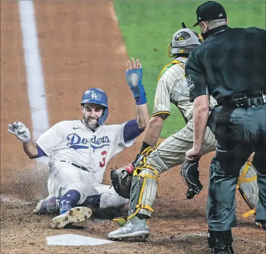  ?? Photog r aphs by Robert Gauthier Los Angeles Times ?? CHRIS TAYLOR, who had walked, slides to score on a sacrif ice f ly by Corey Seager for the Dodgers’ go- ahead run as part of their four- run sixth inning Tuesday night.