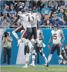  ?? DAVE REGINEK GETTY IMAGES ?? Defensive back Eddie Jackson of the Chicago Bears celebrates his intercepti­on for a touchdown in the fourth quarter with quarterbac­k Chase Daniel and Anthony Miller against the Lions at Ford Field in Detroit on Thursday. The Bears won the game, 23-16.