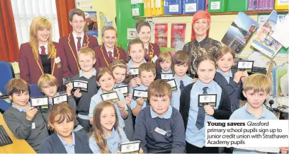  ??  ?? Young savers Glassford primary school pupils sign up to junior credit union with Strathaven Academy pupils