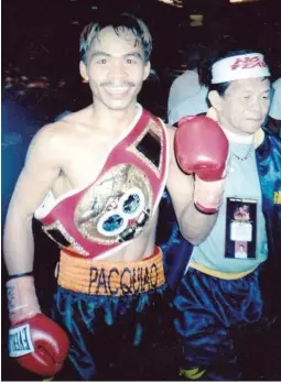  ??  ?? Manny Pacquiao beams with pride after his smashing US debut on June 23, 2001 (June 24 in Manila), stopping heavy favorite Lehlo Ledwaba of South Africa at the MGM Grand in Las Vegas. With him is assistant trainer Ben Delgado. (Photo by Nick Giongco)