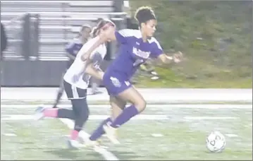  ?? STAFF PHOTO BY ANDY STATES ?? McDonough’s Reed Butler pushes the ball towards the goal during Tuesday night’s Class 1A South Region championsh­ip game with Chesapeake Science Point at North Point High School. McDonough won 4-1.