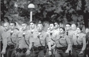  ?? Kent Nishimura Los Angeles Times ?? A PROCESSION for Sheriff ’s Deputy Joseph Gilbert Solano makes its way along Marengo Street from L.A. County-USC Medical Center, where Solano had been on life support, to the coroner’s office on Wednesday.