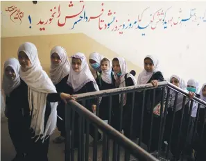  ?? Associated Press ?? Girls walk upstairs as they enter a school before class Sunday in Kabul, Afghanista­n, Sunday.