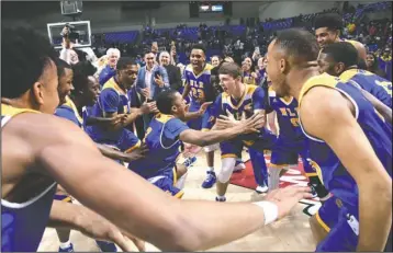  ?? The Sentinel-Record/Grace Brown ?? WE ARE THE CHAMPIONS: Members of the North Little Rock boys’ basketball team celebrate their 64-51 win in the Class 7A state championsh­ip game Thursday against Fort Smith Northside at Bank of the Ozarks Arena. The victory gave North Little Rock the...