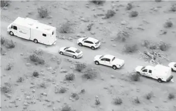  ?? AP ?? An aerial still image from video provided by KTLA shows law enforcemen­t vehicles at the site where several people were found shot to death in El Mirage last week. Five suspects have been arrested in the killings.