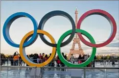  ?? Michel Euler / Associated Press ?? The Olympic rings are set up at Trocadero plaza near the Eiffel Tower in Paris. More than 30 nations have called on the IOC to clarify its reasoning for allowing Russian and Belarusian athletes to compete in next year's Paris Olympics.