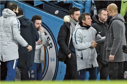  ??  ?? Chelsea coach Maurizio Sarri (second left) leaves the pitch as Manchester City counterpar­t Pep Guardiola (right) is left to shake hands with Chelsea assistant first team coach Gianfranco Zola following their English Premier League match at the Etihad Stadium in Manchester, northwest England, on Sunday. City romped to a surprising­ly one-sided 6-0 victory. — AFP