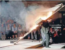  ??  ?? Key player: An actor dressed as assassin Gavrilo Princip carries a burning cross on his back during a performanc­e in Visegrad.