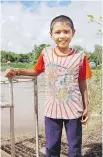  ??  ?? Huy, 11, ran to meet our boat when we arrived at Vihn Hoa village in Vietnam along the Mekong.