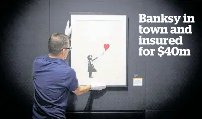  ?? Picture / Michael Craig ?? Organiser Steve Swift puts the final touches to the Art of Banksy exhibition at the Aotea Centre.