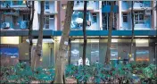  ?? ?? Health workers outside a building placed under a Covid lockdown at the Kwai Chung Estate housing complex in Hong Kong