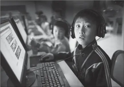  ?? WONG MAYE-E / AP ?? A North Korean schoolboy looks up from his computer screen at the Sci-tech Complex during a press tour for foreign journalist­s on April 17 in Pyongyang, North Korea. Amid all the attention on Pyongyang’s progress in developing a nuclear weapon capable of striking the continenta­l United States, the North Koreans have also quietly developed a cyberprogr­am that is stealing hundreds of millions of dollars and proving capable of unleashing global havoc. North Korea identifies promising students at an early age for special training in computer science.