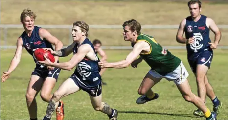  ?? PHOTO: NEV MADSEN ?? LAST MEETING: Coolaroo’s Josh Adams tries to get a kick away while under pressure from Goondiwind­i’s Jack Martin on August 12.