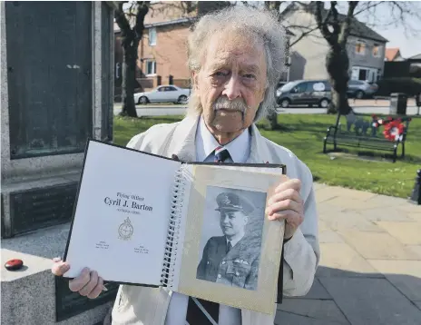  ??  ?? Alan Mitcheson at the war memorial with a book of informatio­n he collated on the incident.