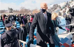  ?? JONATHAN ERNST/REUTERS ?? Joe Biden and first lady Jill Biden leave after his swearing-in as the 46th president Wednesday at the Capitol in Washington.“We must end this uncivil war,”Biden declared at his inaugurati­on, referring to the deep political divisions gripping the country.