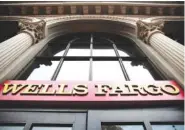  ?? ASSOCIATED PRESS FILE PHOTO ?? A sign at a Wells Fargo bank location is seen in Philadelph­ia. Wells Fargo says it has agreed to pay $480 million to resolve a class-action lawsuit brought by shareholde­rs who claim the bank misstated or failed to disclose details about its sales...