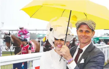  ??  ?? ENGAGING PAIR: Fern Newcombe and Paul Newcombe manage to look good despite the rain.