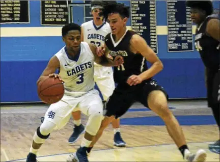  ?? DAVID M. JOHNSON - DJOHNSON@DIGITALFIR­STMEDIA.COM ?? La Salle’s Ray Evans drives the ball as Lansingbur­gh’s Trevor Green during a Colonial Council boys basketball game Tuesday at La Salle Institute in Troy, N.Y.