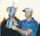  ?? (Reuters) ?? DUSTIN JOHNSON poses with the championsh­ip trophy after winning the US Open golf tournament at Oakmont Country Club in June.