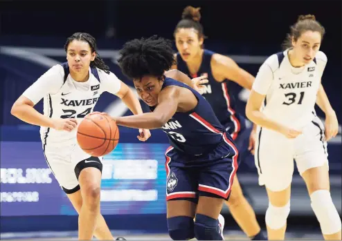  ?? Gary Landers / Associated Press ?? UConn’s Christyn Williams, center, drives the ball upcourt against Xavier on Saturday.