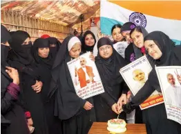  ?? — PTI ?? Women cut a cake in Varanasi on Sunday, ahead of Prime Minister Narendra Modi’s birthday on Monday. Mr Modi will be on a two- day visit to his parliament­ary constituen­cy Varanasi on Monday.