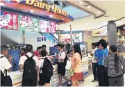  ??  ?? Customers place their orders at a Dairy Queen kiosk in Bangkok. The chain’s franchisee plans to open 40-50 locations a year through 2020.