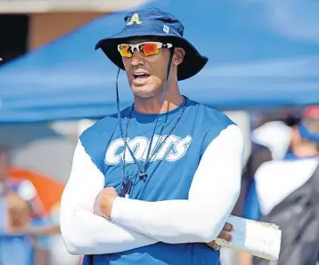  ?? GARY CURRERI/CORRESPOND­ENT ?? Former Miami Dolphins defensive end Jason Taylor, 43, looks on from the sideline while coaching the 12-Under Division team in the Davie/Cooper City Colts organizati­on. The Colts are members of the American Youth Football League.